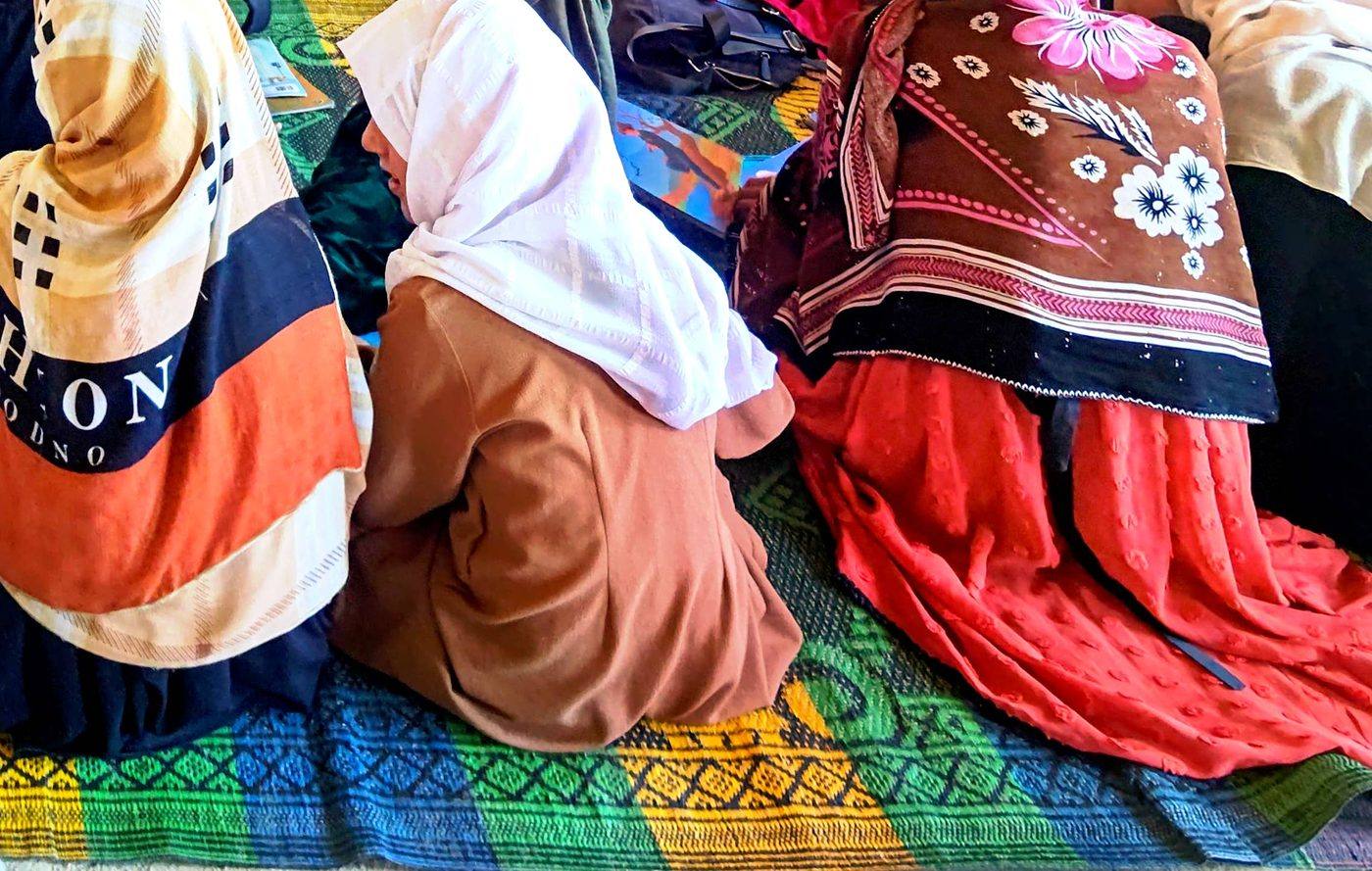 Students seated together on a colourful mat during a lesson in a REN classroom
